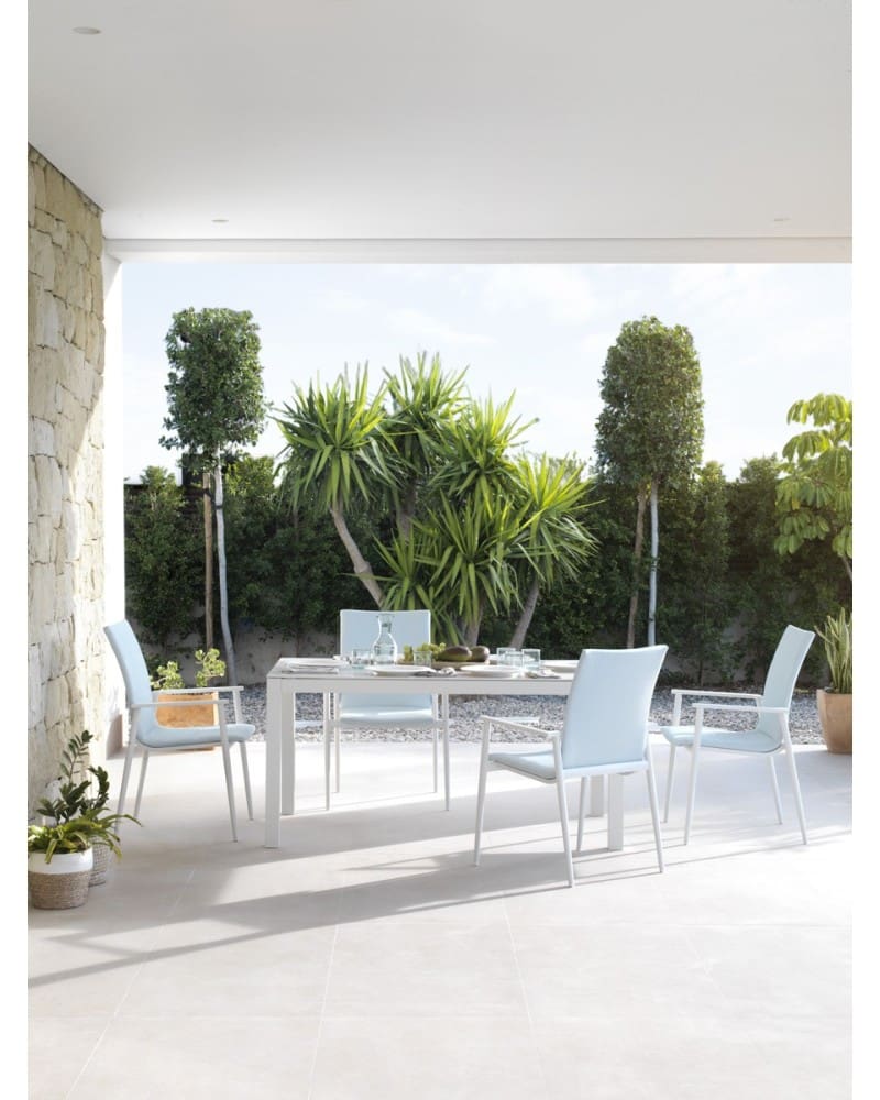 White aluminum armchairs upholstered in light blue.